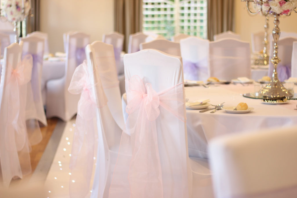 White Chair Covers with Pale Pink Sashes