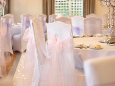 White Chair Covers With Pale Pink Sashes