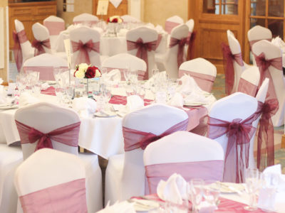 Chair Covers With Red Sashes Wedding Decoration